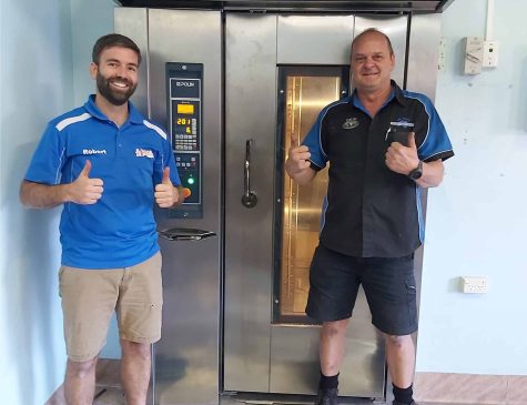 Two men in hospitality happy with their bakery equipment